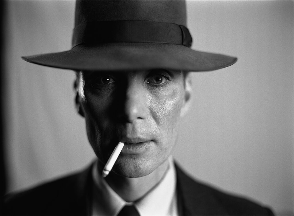 Cillian Murphy in black and white promotional photo wearing hat and suit for best actors of the decade article